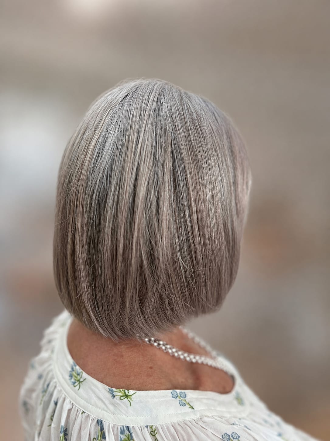 A short, finished silver bob